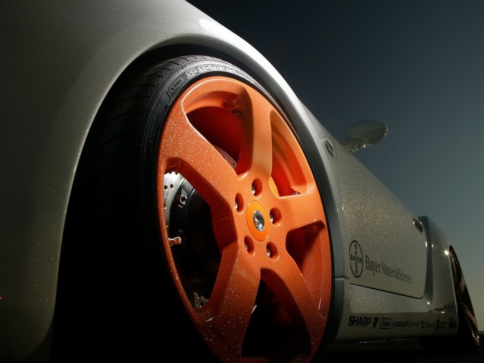 Custom orange rims on a white sports car