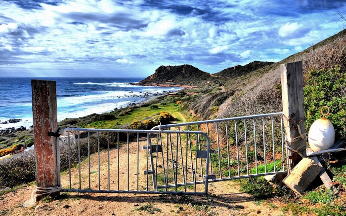 Coastal landscape with a gate and the sea