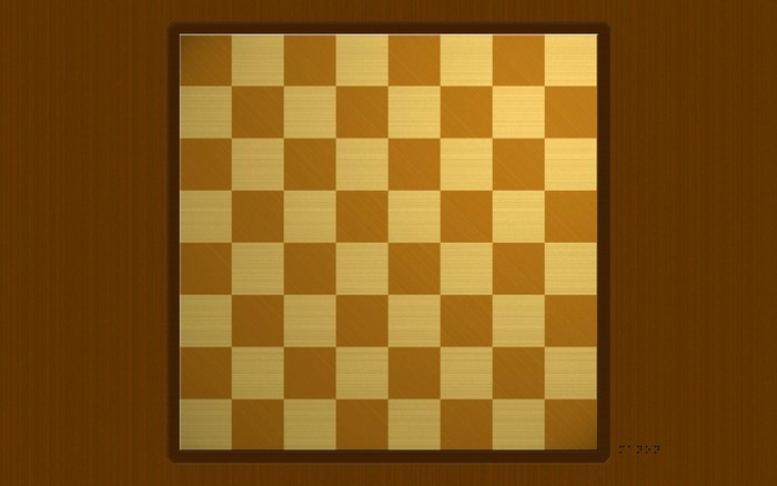 A wooden chessboard with brown and gold squares