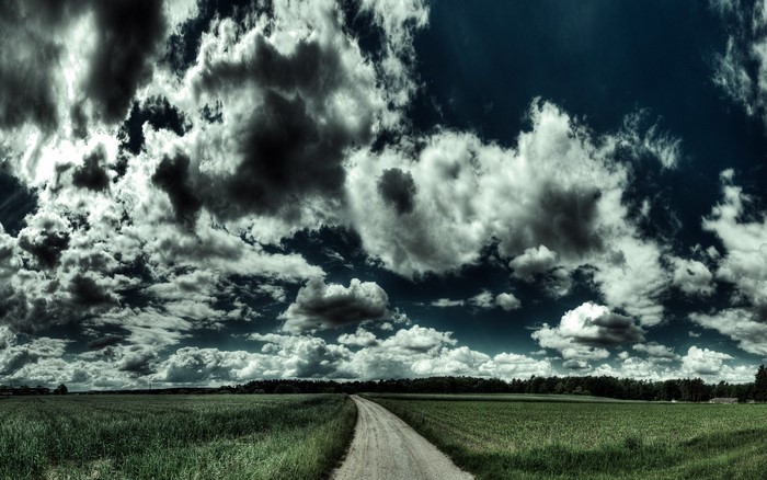 Stormy Sky Over a Rural Field with a Dirt Road