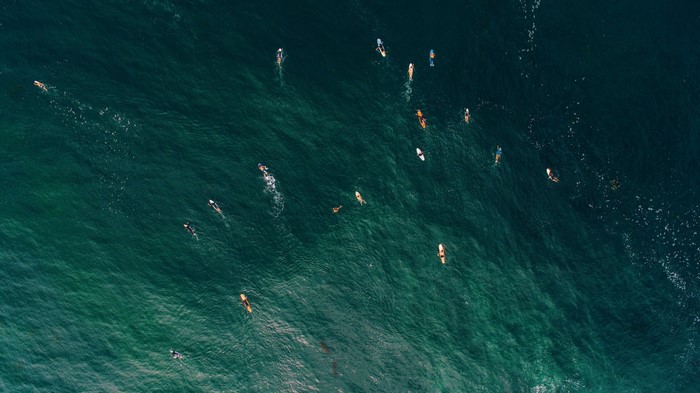Surfers on the ocean waves from above