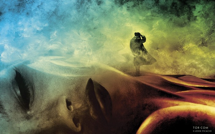 Surreal desert landscape with a figure and a giant face