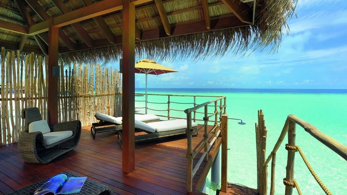 Tropical resort with overwater bungalow and turquoise ocean
