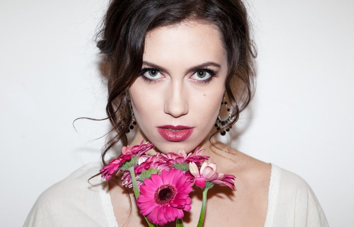 Woman with pink flowers and dark hair