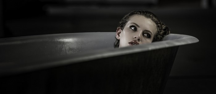 Woman with wet hair in a bathtub
