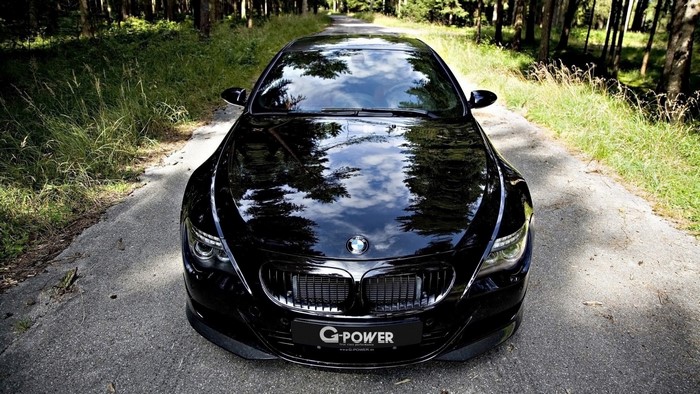 Black BMW M6 Hurricane RR parked on a forest road