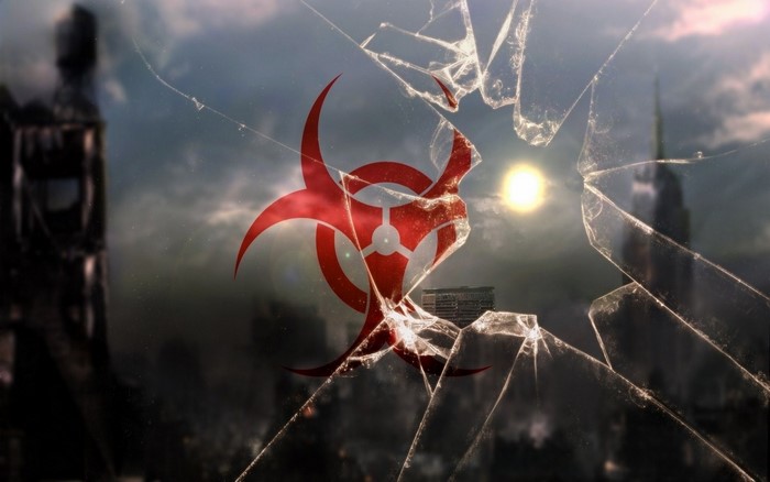 Biohazard symbol on cracked glass over city