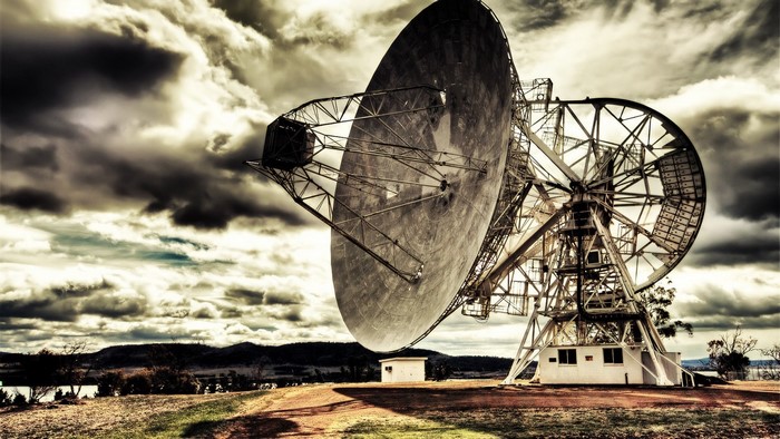Radio telescope against a dramatic cloudy sky