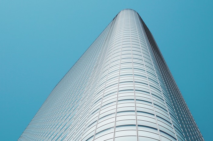 Modern glass skyscraper against a clear blue sky