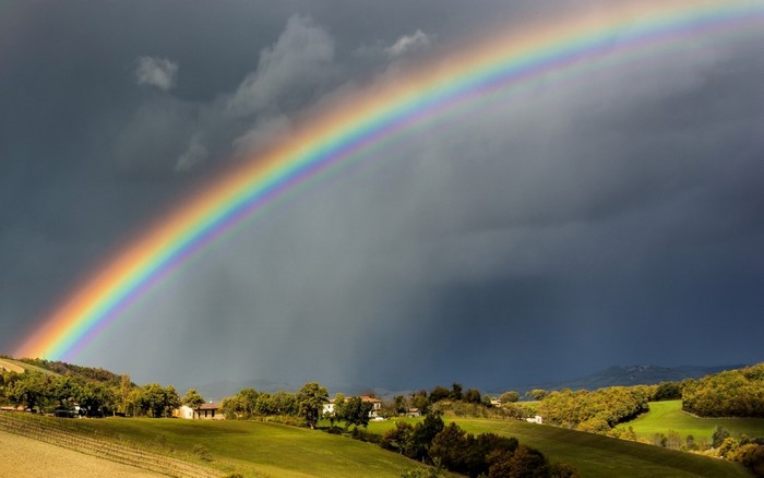 Rainbow over rolling hills and fields
