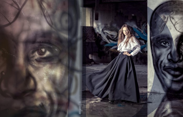 Woman in dark skirt and white shirt with graffiti art
