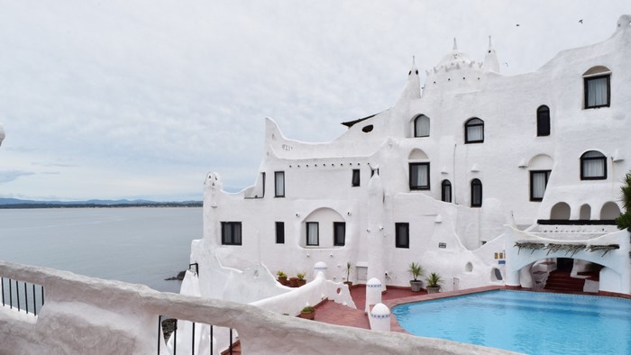 White building with swimming pool overlooking the sea in Uruguay