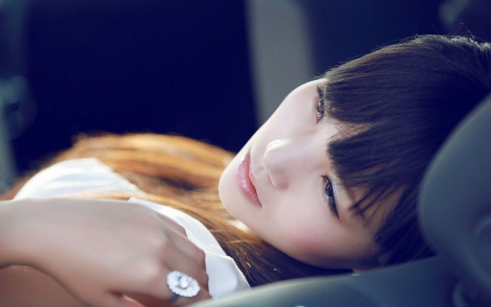 Asian woman with dark hair and a ring