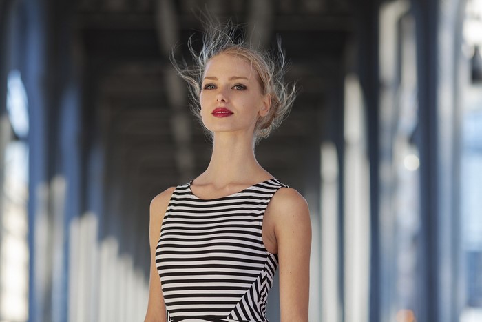 Woman with blonde hair in a striped dress