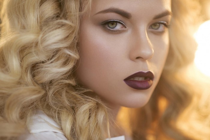 Close up portrait of a blonde woman with dark lipstick