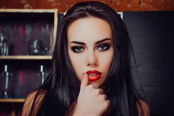 Woman with red lipstick and black hair posing