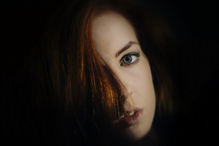 Close up portrait of a redhead woman with blue eyes