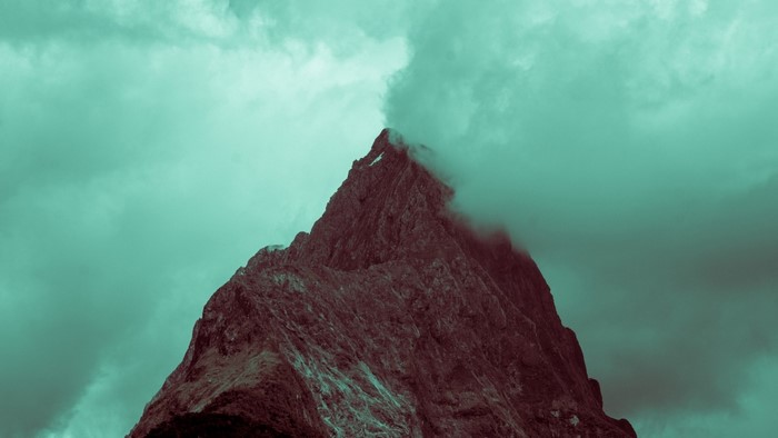 Mountain peak shrouded in mist and clouds