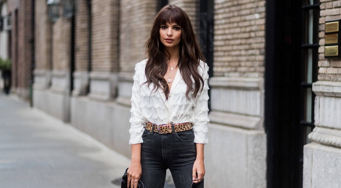 Emily Ratajkowski wearing a white top and jeans
