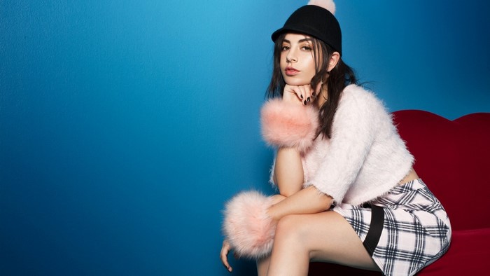 Woman wearing a fuzzy sweater and plaid skirt