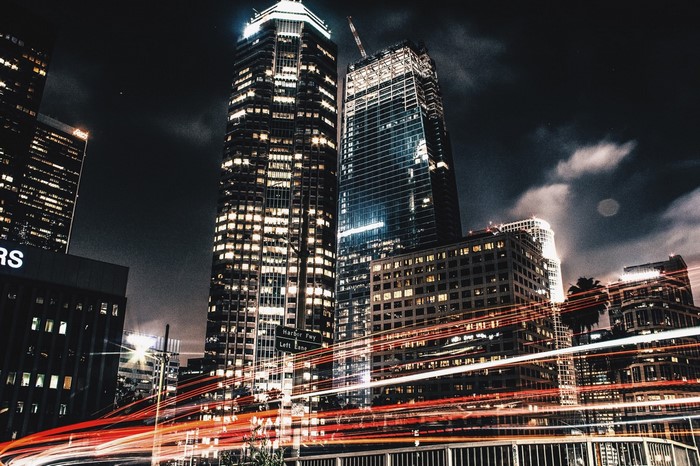 Cityscape at night with light trails from traffic
