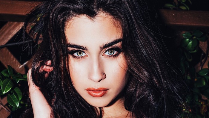 Lauren Jauregui portrait with dark hair and green eyes