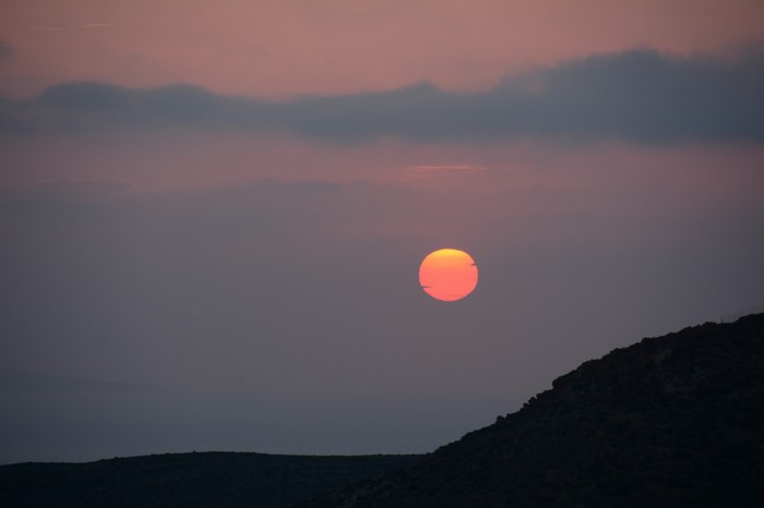 Sunset over a rocky landscape with clouds