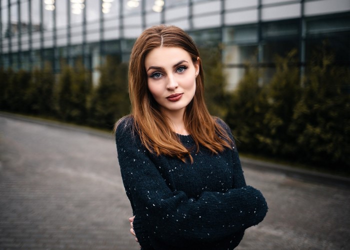 Woman with brown hair wearing a dark sweater