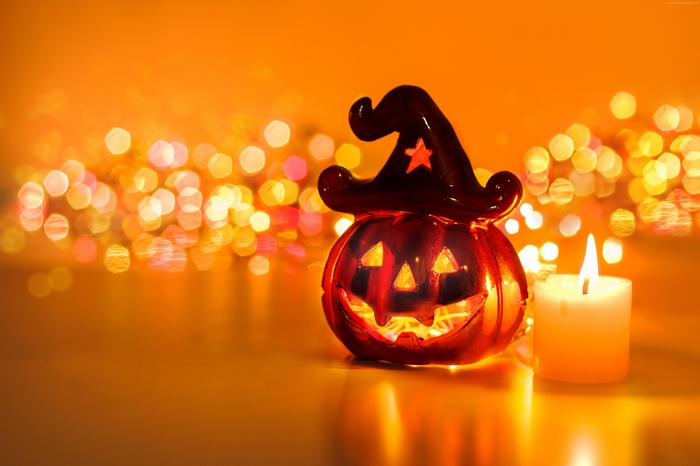 Halloween pumpkin decoration with candle and bokeh lights