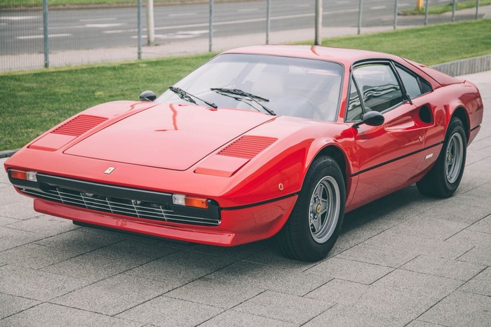 Red Ferrari 308 GTB parked on a paved surface