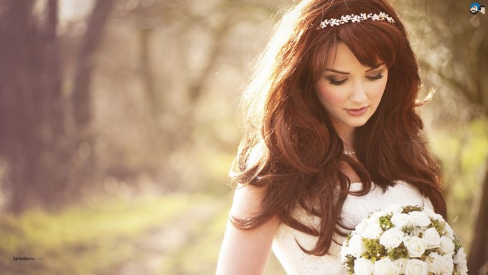 Bride with bouquet and floral headband outdoors
