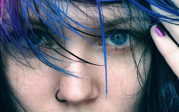 Close up of a woman with blue hair and blue eyes