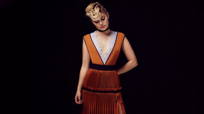 Olivia Holt in orange dress with lace trim