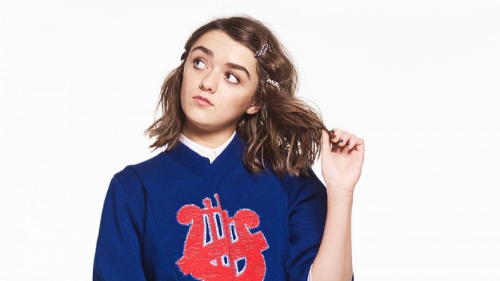 Maisie Williams in blue sweater with red graphic