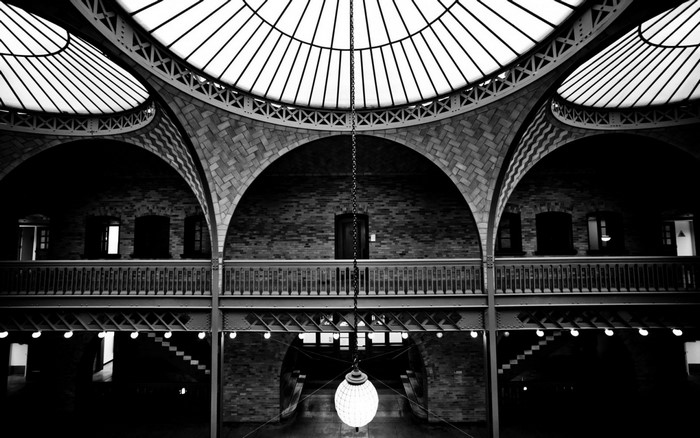 Monochrome interior of a building with arches and a glass ceiling
