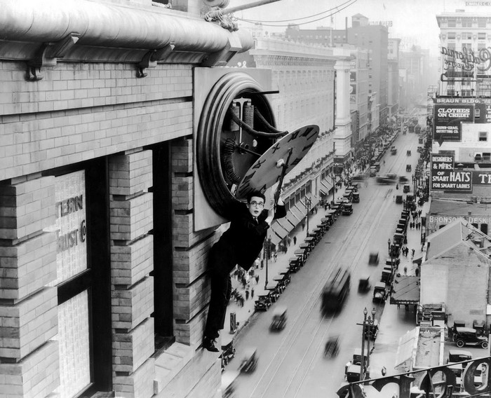 Harold Lloyd hanging from a clock in Safety Last!