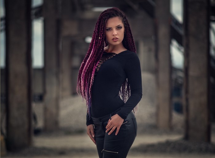 Woman with purple dreadlocks in black outfit