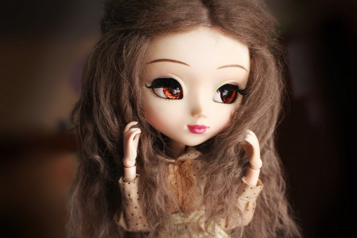 Close up of a doll with brown hair and large eyes