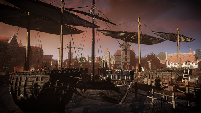 Ships docked in a medieval town at dusk