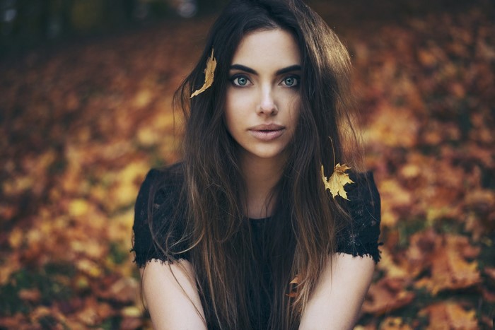 Woman with leaves in her hair in autumn