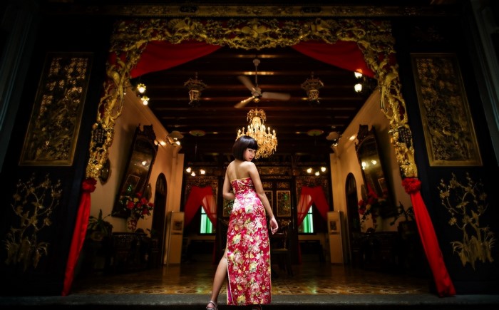 Woman in a floral dress in a traditional Chinese interior