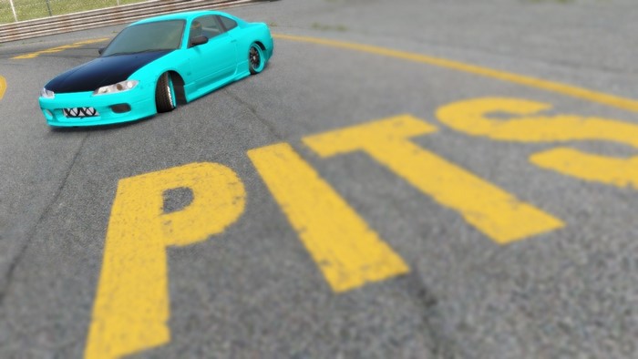 Cyan sports car on a race track with 'PITS' marking