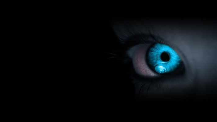 Close-up of a blue eye with a water droplet
