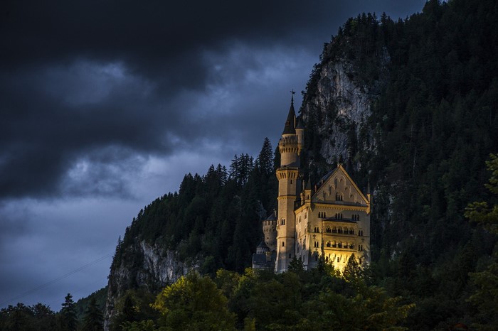 Neuschwanstein Castle at dusk with stormy clouds