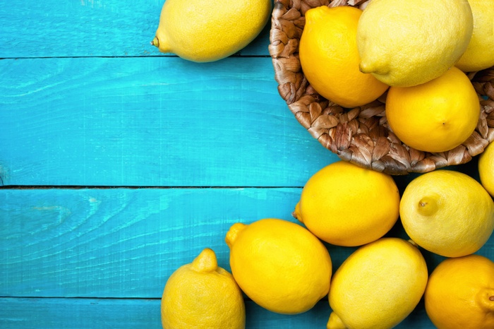 Lemons in a basket on a blue wooden table