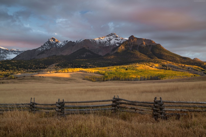 Mountains in Colorado with Autumn Trees and Wooden Fence
