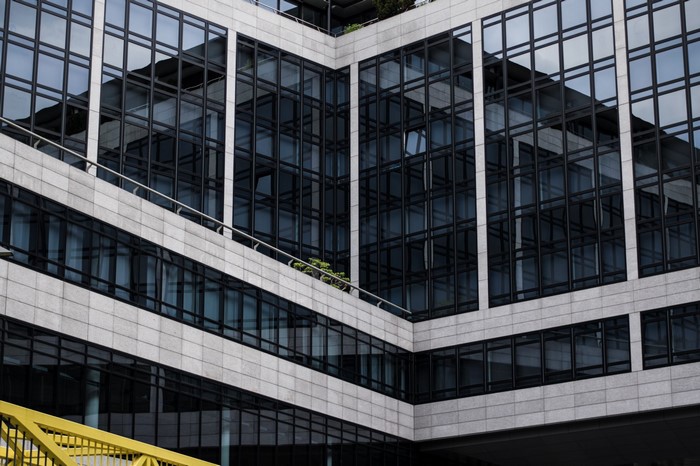 Modern building facade with glass windows and concrete elements