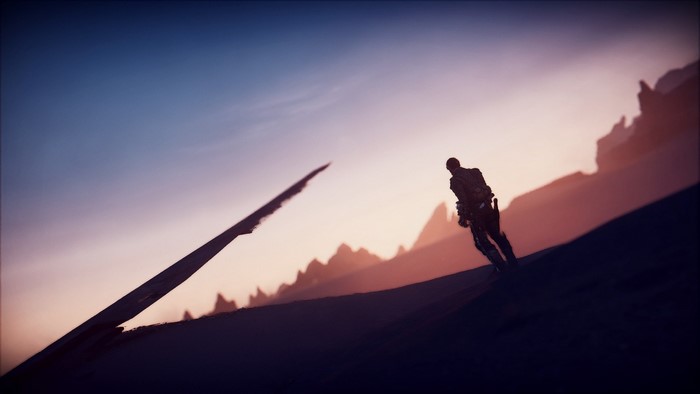 Silhouette of a person in a desert landscape at sunset