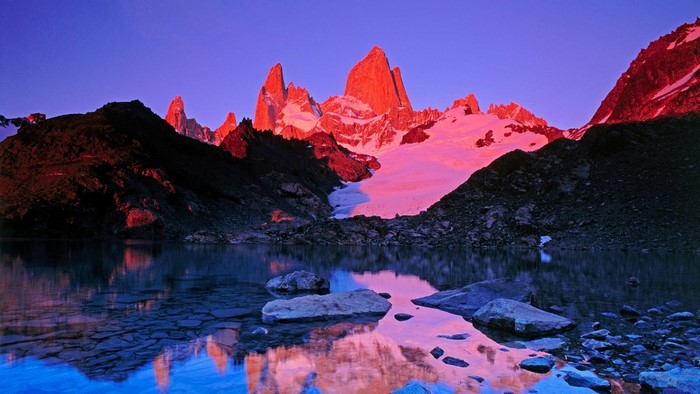 Mountain range reflected in a lake at dusk