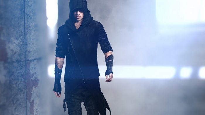 Man in black hoodie and pants with tattoos